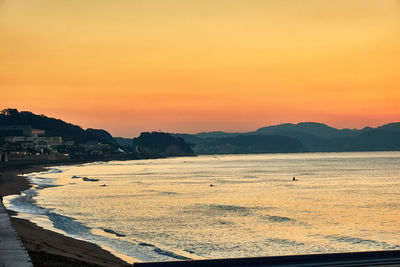 Scenic view of sea against orange sky