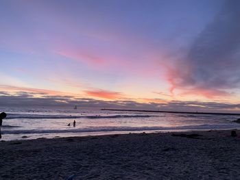 Scenic view of beach against sky during sunset