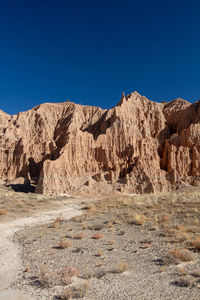 Scenic view of rocky mountains against clear blue sky