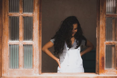 Woman standing against door