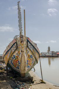 Boats moored on beach against sky