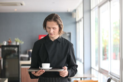 Woman holding coffee cup