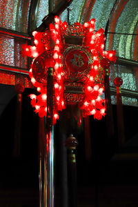 Low angle view of illuminated lanterns hanging in building