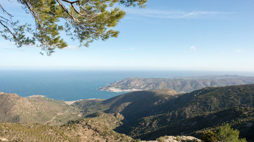 Scenic view of sea and mountains against sky