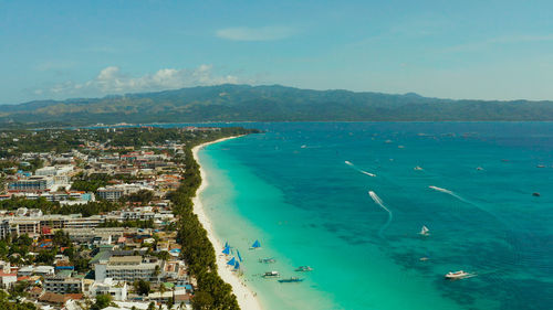 Tropical beach with tourists and clear blue sea, top view.  boracay, philippines