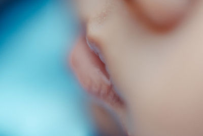 Close-up of woman over blue background