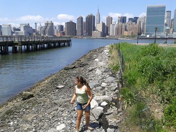 Woman standing by railing in city