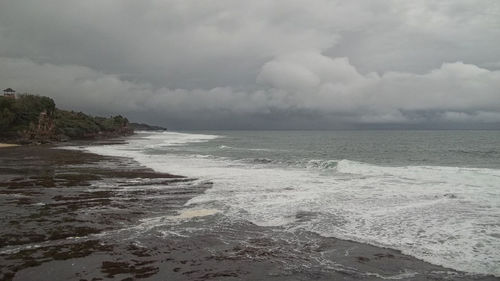 Scenic view of sea against storm clouds