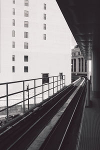 Railroad station in city against sky