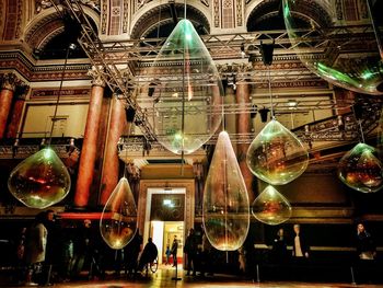 Low angle view of illuminated lanterns hanging in glass