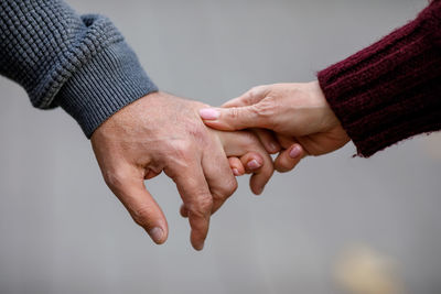 Elderly couple holding hands