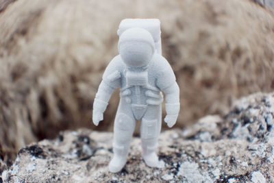 Close-up of figurine on abstract background