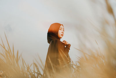 Woman with umbrella on field