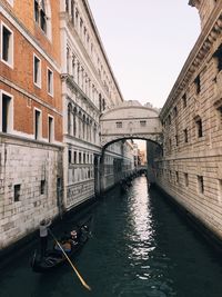 View of canal amidst buildings against sky