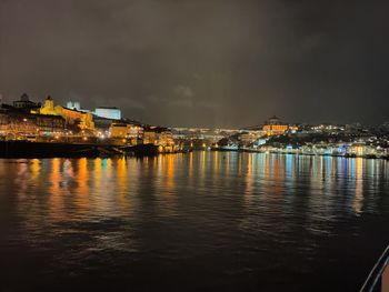 Illuminated city at waterfront