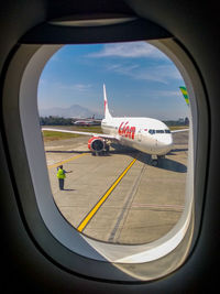 View of airplane seen through window