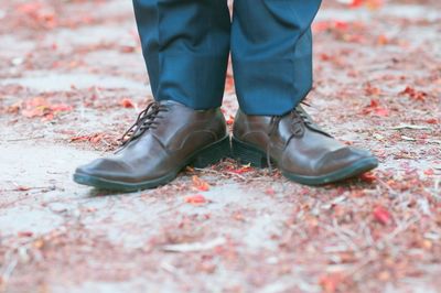 Low section of man wearing shoes