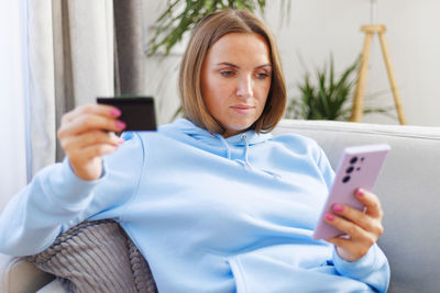 Young woman using mobile phone