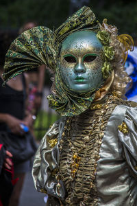 Person in costume wearing venetian mask during carnival