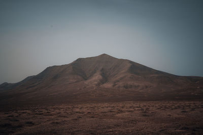 Scenic view of arid landscape against sky