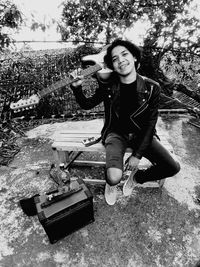 Portrait of a smiling young woman sitting outdoors