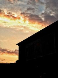 Low angle view of built structure at sunset