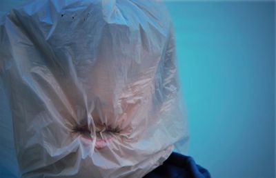 Close-up of person covered with plastic bag