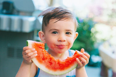 Portrait of boy eating food