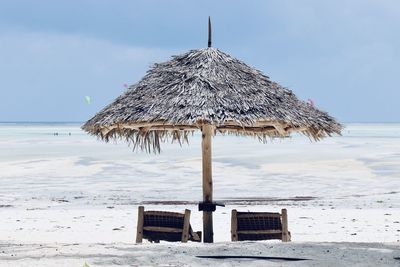 Lifeguard hut on beach against sky