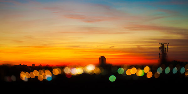 Scenic view of silhouette city against sky during sunset