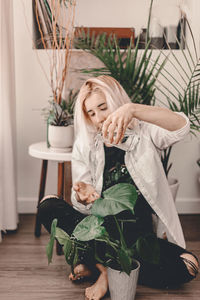 Young woman with potted plants