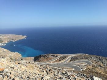 High angle view of sea against clear blue sky