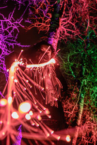 Low angle view of illuminated christmas tree at night