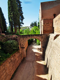 Footpath amidst buildings against clear sky