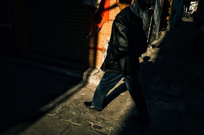 Low section of man walking on footpath