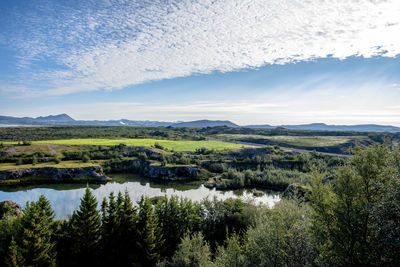 Volcanic lake myvatn with reflections and islands, green meadows and blue skies in northern iceland