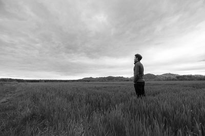 Man standing on field against sky