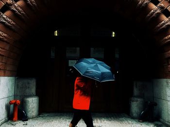 Full length of woman standing in front of building