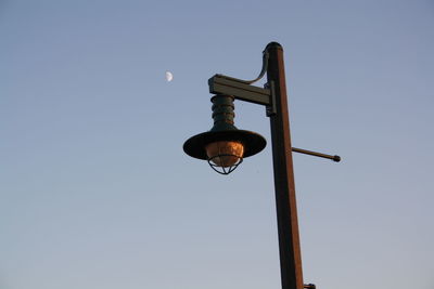 Low angle view of cross against clear blue sky