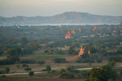 Panoramic view of pagodas in green fields in bagan
