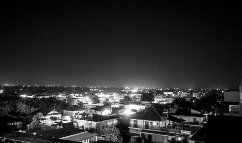 High angle shot of illuminated townscape against sky at night