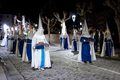 Rear view of people walking on street