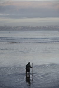 Man on beach against sky