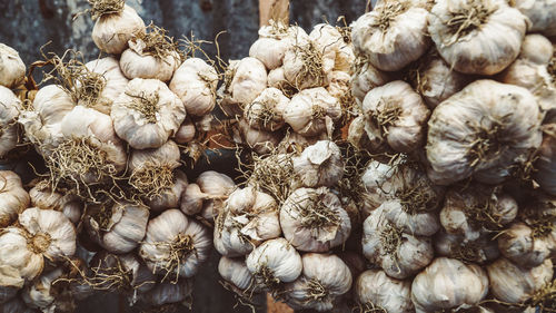 Close-up of garlics hanging for sale at market