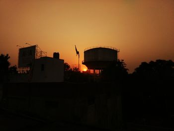 Silhouette of building against sky during sunset