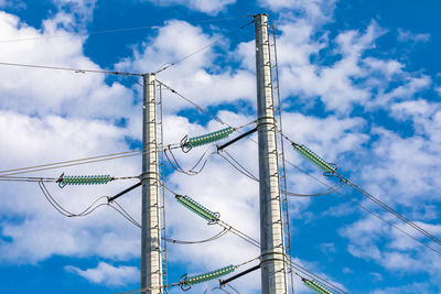 Low angle view of communications tower against blue sky