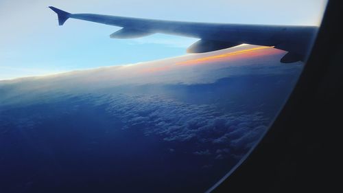 Cropped image of airplane wing over landscape