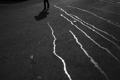 Low section of silhouette man running on street