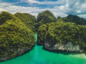 Scenic view of river against cloudy sky