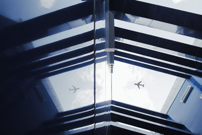 Low angle view of building seen through airplane window